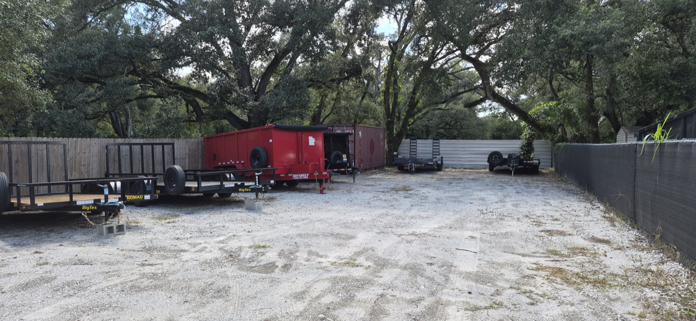 The gated Westshore Rentals yard in Tampa, trailers lined up and ready for collection